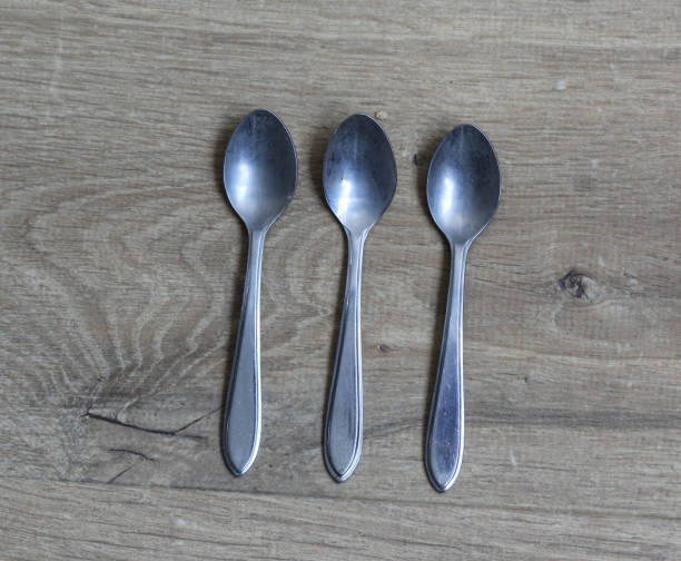 istock Set of silver tea spoons on wooden background 925432584