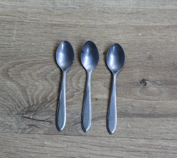 istock Set of silver tea spoons on wooden background 925432604