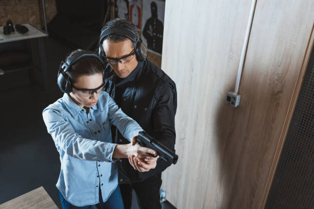 istock overhead view of instructor helping customer in shooting gallery 925435374