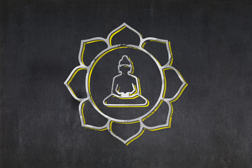Blackboard with the Buddha inside a lotus flower symbol from the Mahayana Buddhism drawn in the middle.