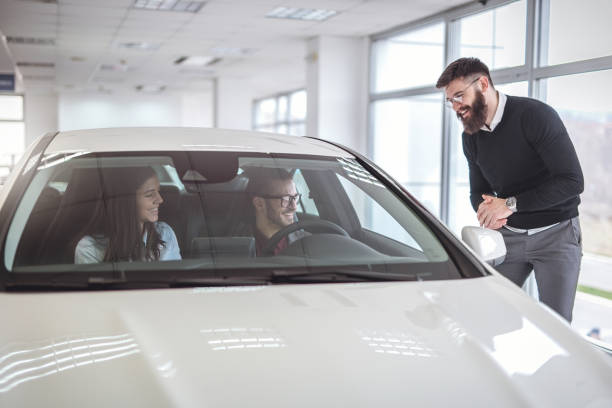 istock Couple buying a new car 925440012