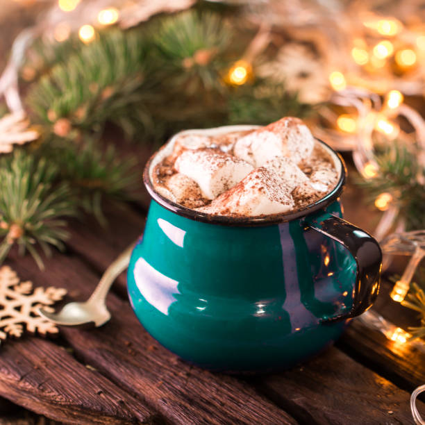 istock Enamel cup of hot cocoa with marshmallows on rustic wooden background 925440220