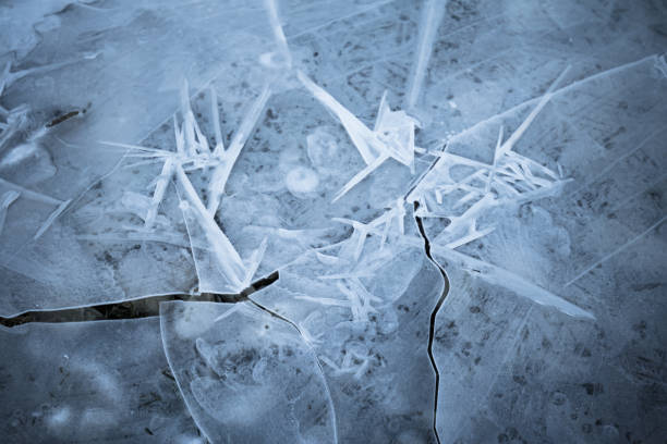 istock close up on thin frozen ice plaques on lake in wintertime, background texture 925443164