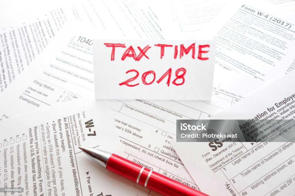 Workspace with various US forms Workspace with various US forms. Tax time 2018 2018 Stock Photo