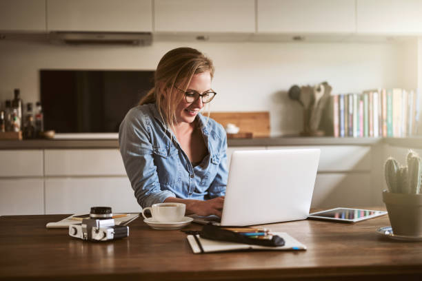istock Smiling female entrepreneur working from home with a laptop 925450264