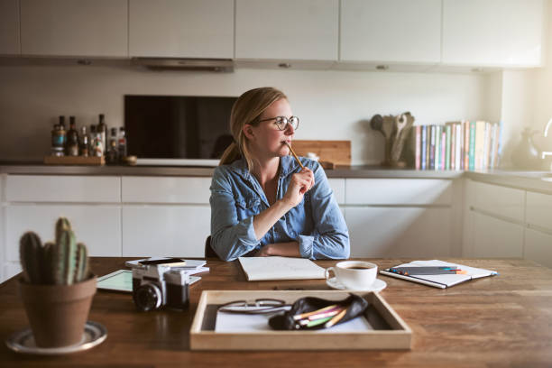 istock Young female entrepreneur deep in thought while working from home 925450400