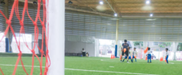 istock Indoor soccer training field blur abstract for background 925450716