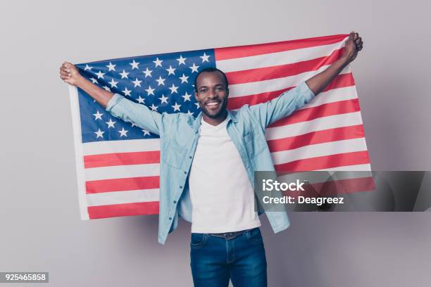 Its My Native Country Portrait Of Cheerful Glad Excited Confident With Toothy Beaming Smile Student Wearing Denim Casual Outfit Holding Flag Of The Usa Isolated On Gray Background Stock Photo - Download Image Now