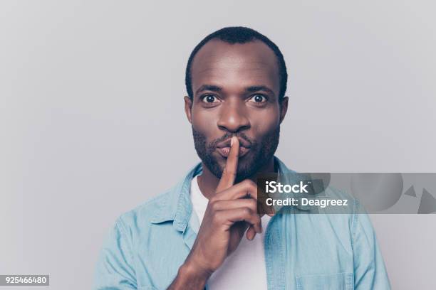 Just Dont Speak Close Up Portrait Of Handsome Cheerful Mysterious Silent Man Making Hush Gesture Isolated On Gray Background Stock Photo - Download Image Now
