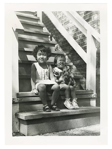 istock Two Asian Children Sitting on Outside Stairs 92546786