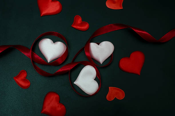 istock ribbon with hearts on a black background 925470460