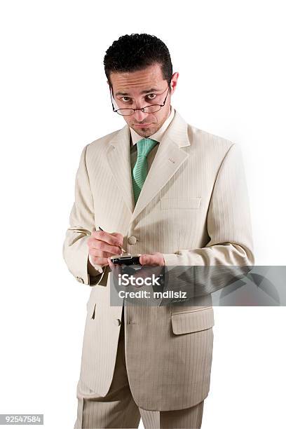 Hombre De Negocios Con Gafas Mirando Sobre Su Pda Foto de stock y más banco de imágenes de Adulto - Adulto, Aguja del tocadiscos, Azul