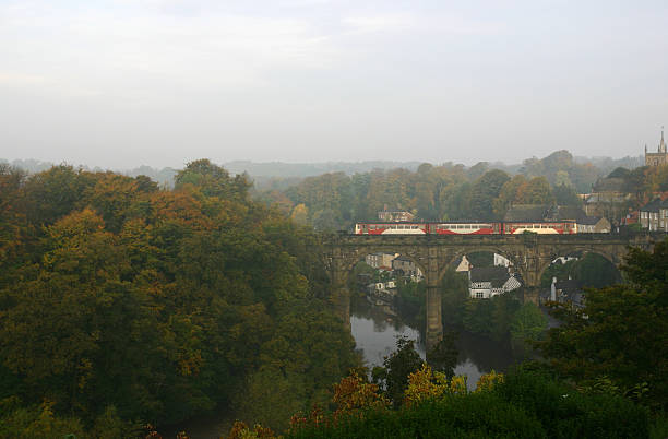 istock autumn colours with train crossing railway bridge over river, Kn 92548479