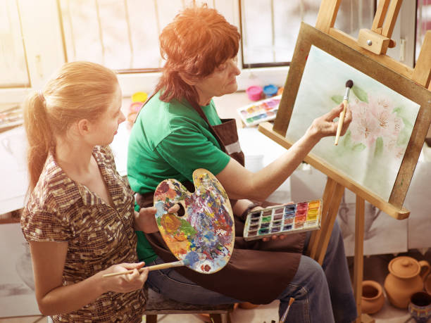 istock Artist painting on easel in studio. Authentic children paints . 925488936