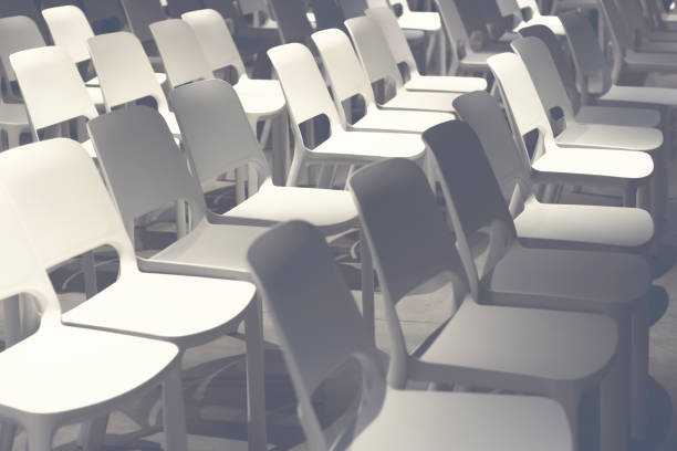 istock Empty white chairs arranged before the performance, conference. Defocus. Toned photo. Selective focus 925489094