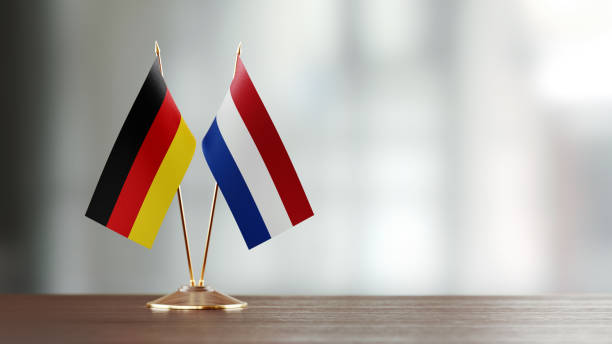 istock German And Dutch Flag Pair On A Desk Over Defocused Background 925492250