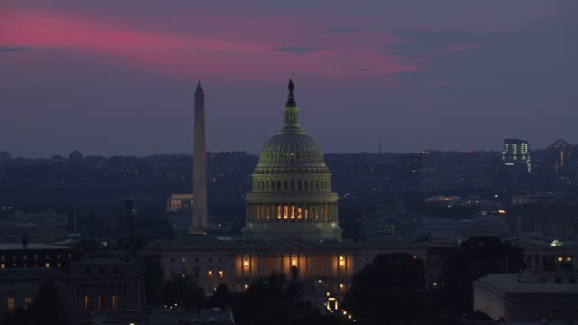 Aerial view of US Capitol Building at dusk.