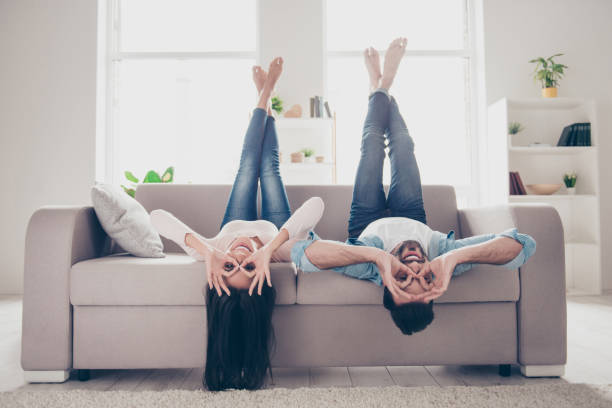 We go crazy and have fun together! Beautiful cheerful delightful humorous couple of two lovers clothed in casual denim outwear, demonstrating binoculars using hands, lying upside-down We go crazy and have fun together! Beautiful cheerful delightful humorous couple of two lovers clothed in casual denim outwear, demonstrating binoculars using hands, lying upside-down delightful stock pictures, royalty-free photos & images