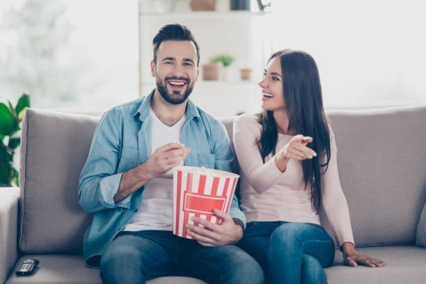 istock The actor is so amusing comical and  
laughable! Cheerful excited amazed glad delightful beautiful wearing casual outfit they are watching tv and spending time together 925492694