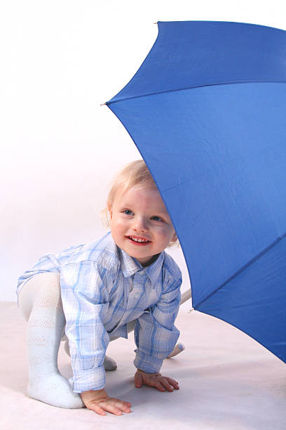 istock Little boy and blue umbrella 92549307