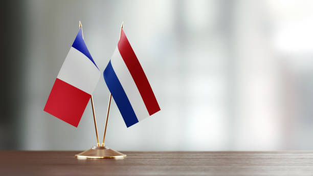 istock French And Dutch Flag Pair On A Desk Over Defocused Background 925493580