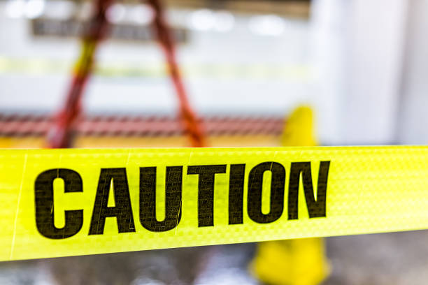 istock Caution tape sign in underground transit empty large platform in New York City NYC Subway Station in Grand Central, ladder, wet floor cone 925494448