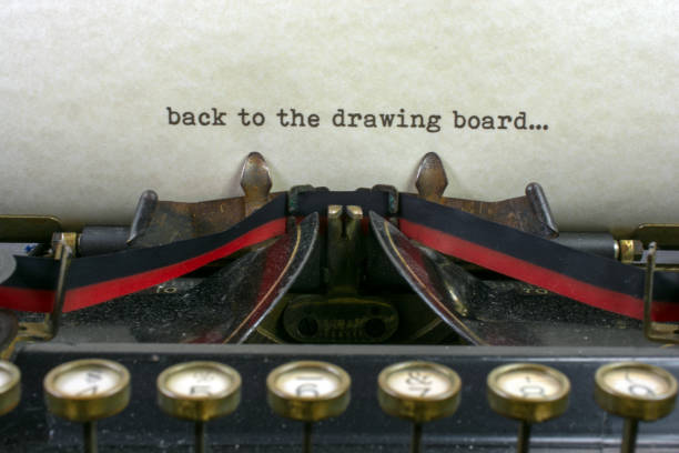 istock Antique typewriter with saying back to drawing board 925494650