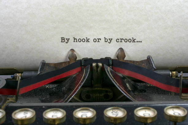 istock Antique typewriter with saying hook or by crook 925494722