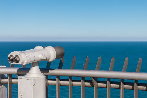istock White binoculars staring at clear blue sea horizon 925494932