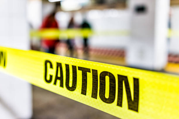 istock Caution tape sign in underground transit empty large platform in New York City NYC Subway Station in Grand Central, ladder, wet floor cone 925494980