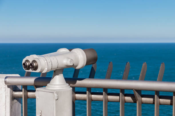 istock White binoculars staring at clear blue sea horizon 925495016