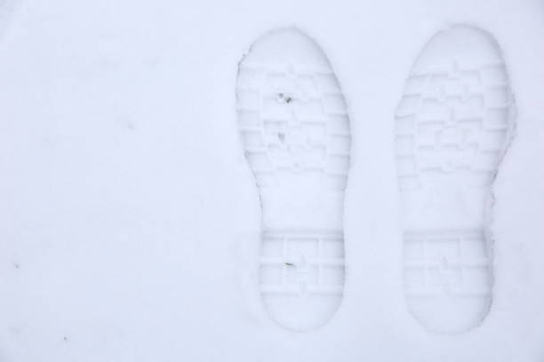 istock Footprints of shoes on fresh snow. 925498202