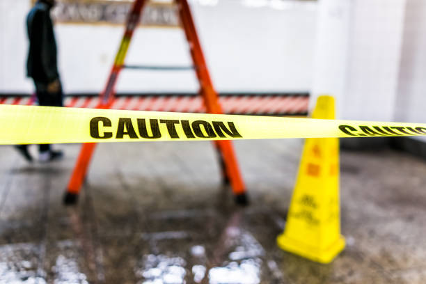 istock Caution tape sign in underground transit empty large platform in New York City NYC Subway Station in Grand Central, ladder, wet floor cone 925501218