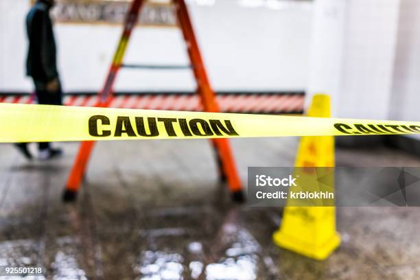 Caution Tape Sign In Underground Transit Empty Large Platform In New York City Nyc Subway Station In Grand Central Ladder Wet Floor Cone Stock Photo - Download Image Now