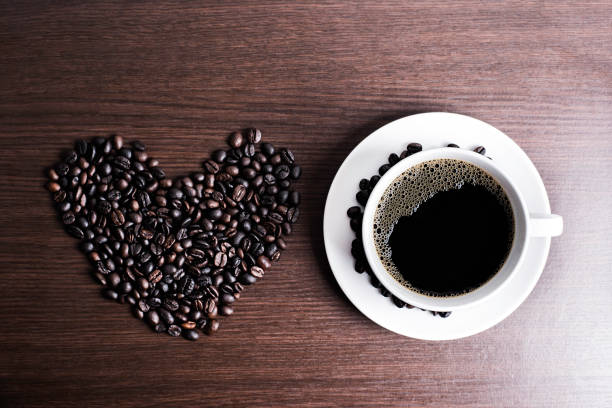 istock Black coffee in white cup and coffee bean on wood table background. 925511114