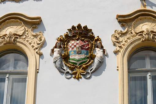 official coat of arms of the Netherlands on a brick wall