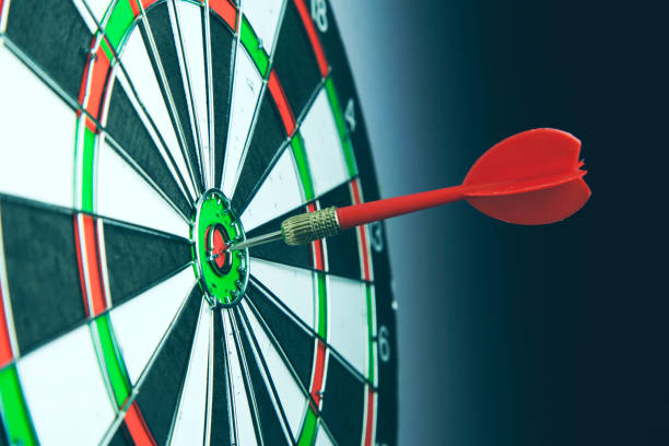 istock Right on target concept using dart in the bullseye on dartboard 925512084