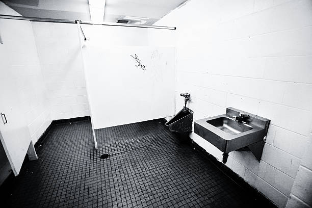 Top view of a man legs in front of urinal in men toilet