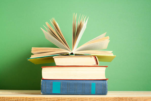 istock Open book, hardback books on wooden table. Education background. Back to school. Copy space for text. 925529984