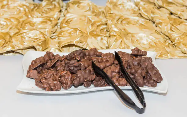 Photo of Chocolate Peanut Clusters Arrangement at White and Gold Themed Party