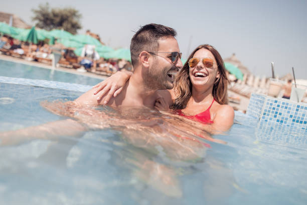 istock Happy young couple having fun in the water 925534264