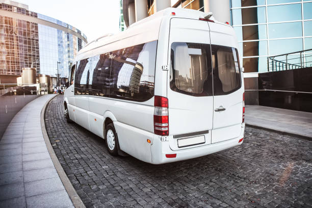 istock White mini bus moves down the street 925534954