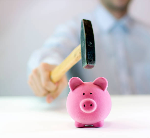 istock Pink piggy bank and hand with hammer 92554308