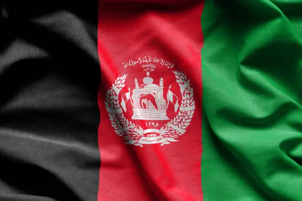 Colorful, closeup, wavy fabric flag of Afghanistan fills the frame