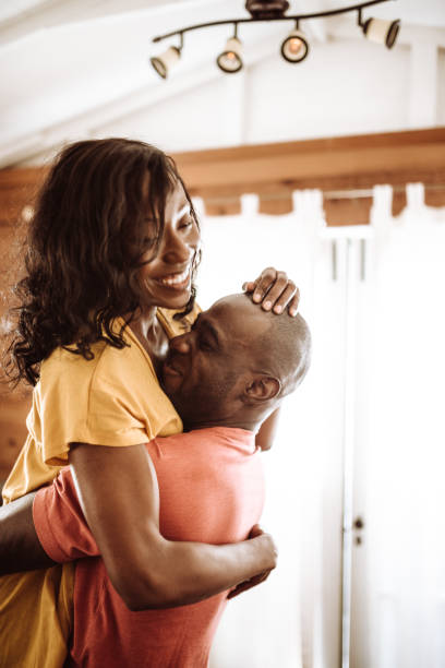 istock couple embracing in the kitchen 925552520