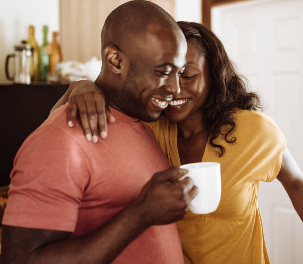 istock couple embracing in the kitchen and take a coffee 925552584