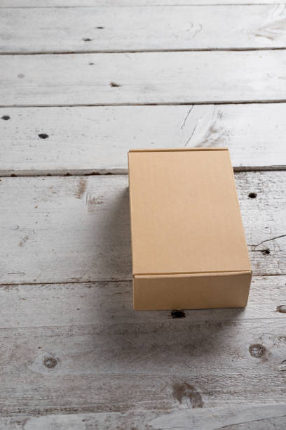 istock Cardboard box on a wooden background 925553482