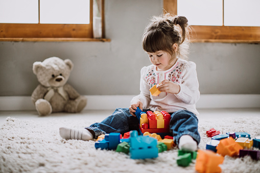 Child playing with plastic blocks