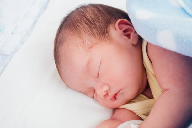 istock Newborn baby girl sleeping 925560542