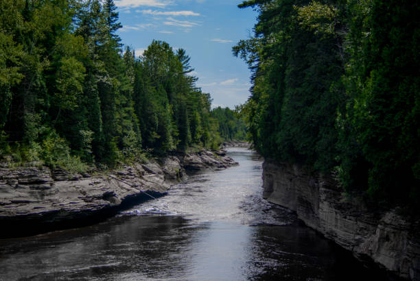 istock Sunny day outdoor at a river surrounded by rock and trees 925561018